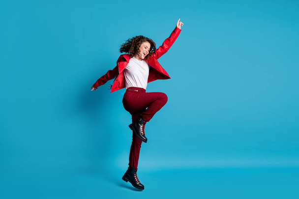 Full size profile photo of hooray girl jump wear red jacket trousers boots isolated on blue color background - Foto, Imagen