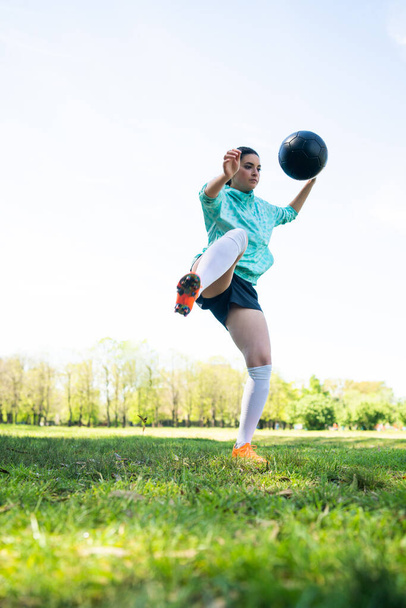 Young woman practicing soccer skills with ball. - Foto, Imagen