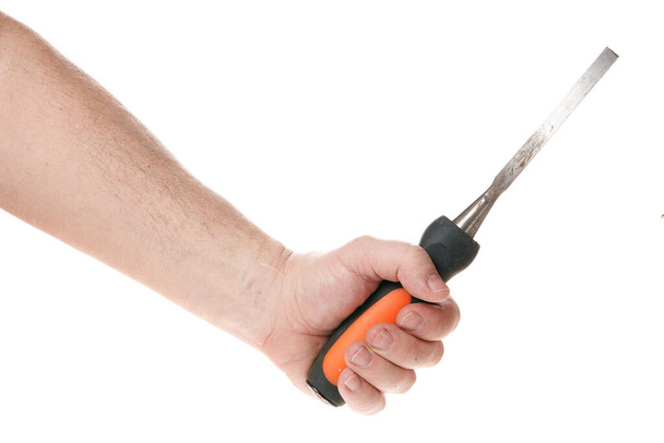 Hand holds a chisel on a white background, template for designers. Close up - Foto, imagen