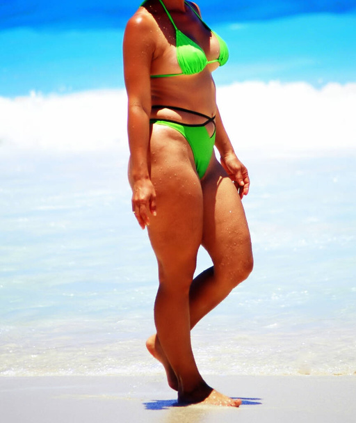 Sexy female beauty in a bikini on the beach outdoors. - Foto, Imagem