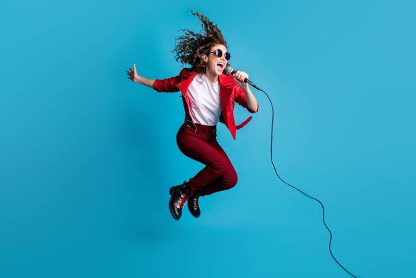 Full body profile photo of excited carefree person jump singing open mouth have fun isolated on blue color background - Fotoğraf, Görsel