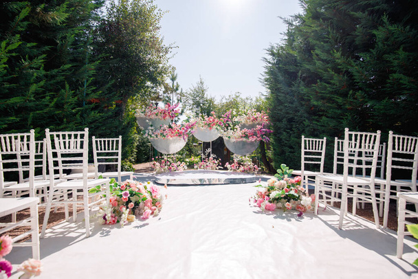 Decorative design of a wedding arch with flowers. - Фото, зображення