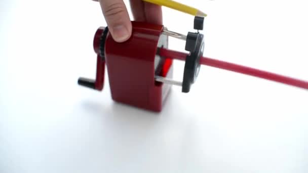 hand holds Mechanical pencil sharpener with colored pencils on white background. back to school. preparing for school stationery for study - Video
