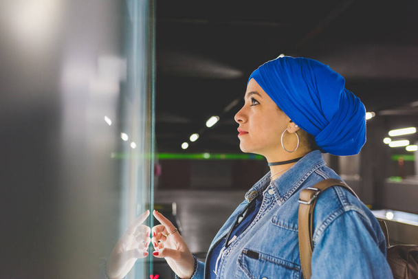 Mujer joven árabe usando hijab comprar boleto - Foto, imagen