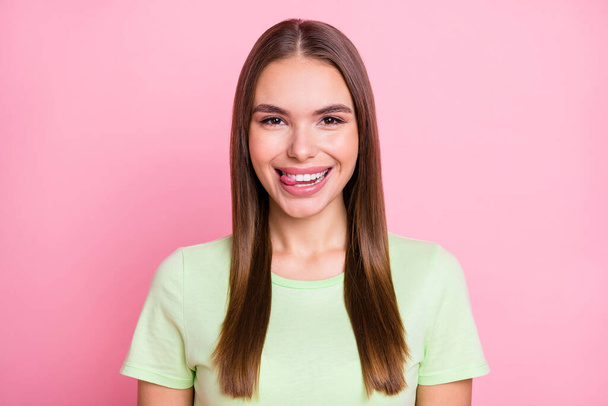 Photo of funny flirty young lady wear green t-shirt licking lips isolated pastel pink color background - Foto, afbeelding