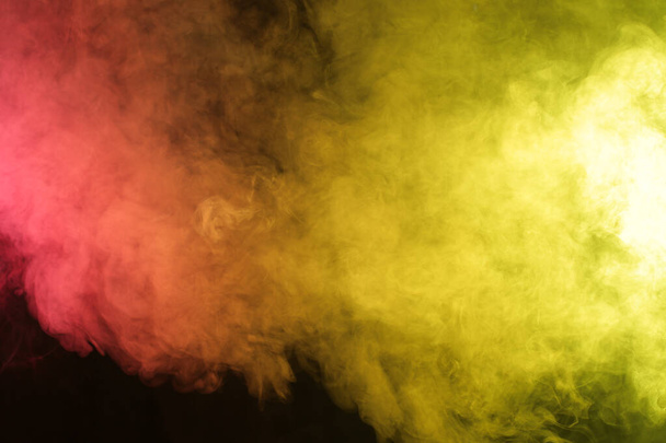 Magic Smoke in red-yellow light on black background - Foto, immagini