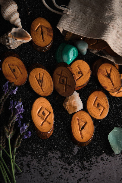homemade wooden runes on a dark background - Foto, Imagem