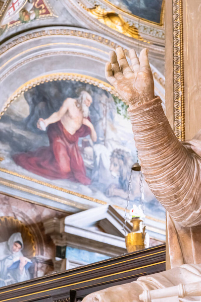 View of colorful fresco and hand of sculpture inside catholic church in Rome - Photo, Image