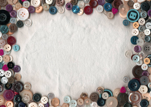 Sewing color buttons frame on fabric texture background. Collection of assorted spare clothes buttons vintage. Sewing tools close up.  - Фото, зображення