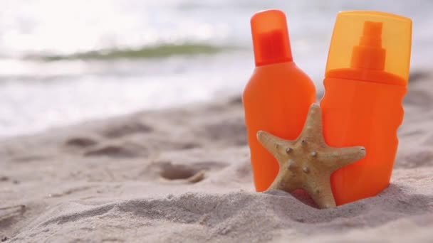 Sunscreens on the beach near the sea close up - Footage, Video