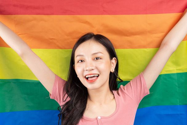 Młoda Azjatka z tęczową flagą wspierająca społeczność LGBTQ + - Zdjęcie, obraz