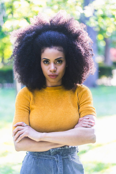 Portrait of nice afro girl in a garden. Mid shot. - Photo, Image