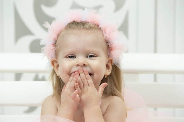Portrait of a little cheerful girl with pink bows. Two-year-old child. - Photo, Image