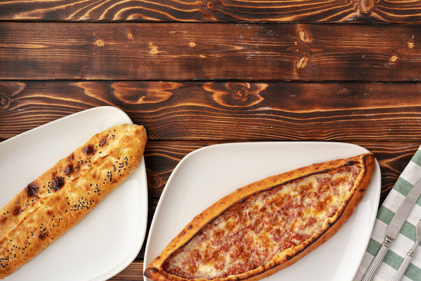 Pide - Turkish baked bread on wooden table - Foto, imagen