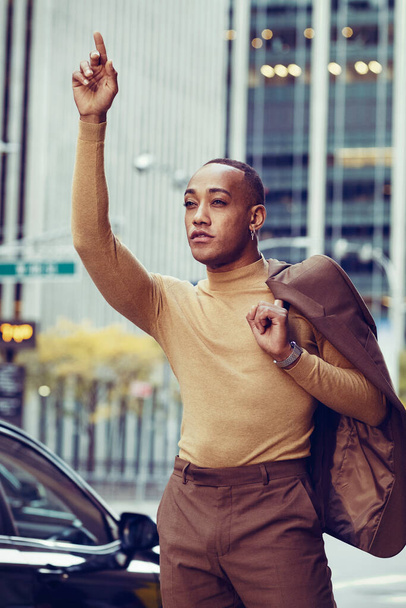 Jóképű afro-amerikai férfi öltönyben pózol a modern városi háttér - Fotó, kép