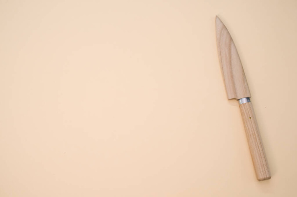 A closeup shot of a classic Japanese knife isolated on a pink background with copyscape - Photo, Image
