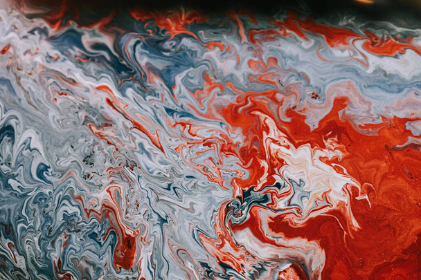 A closeup shot of a colorful mix of oil paints on the water, colorful painting background - Foto, Imagen