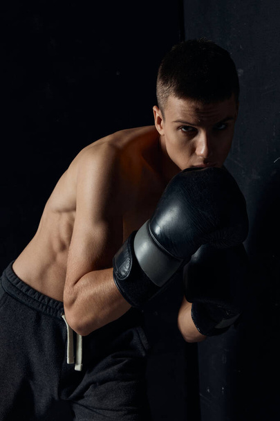 boxers two black gloves bent down sport bodybuilder pumped up torso - Fotografie, Obrázek