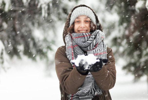 Young cheerful woman glad to snow - Фото, изображение