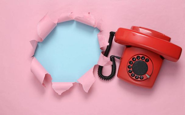 Torn hole and retro rotary phone on blue-pink pastel background. Concept art. Pastel color trend. Copy space. Minimalism - Fotoğraf, Görsel