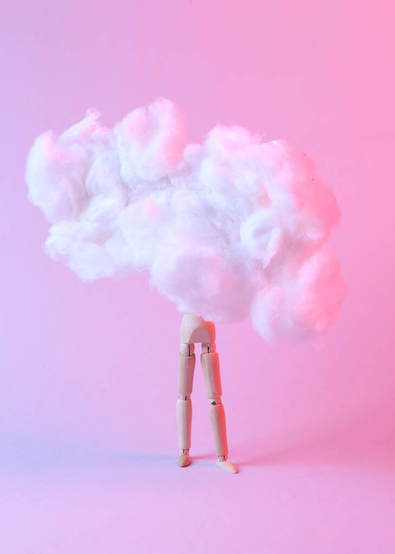 Wooden puppet in floating fluffy cloud. Blue pink neon gradient light. Creative idea. Concept art. Minimalism. Surrealism - Фото, зображення