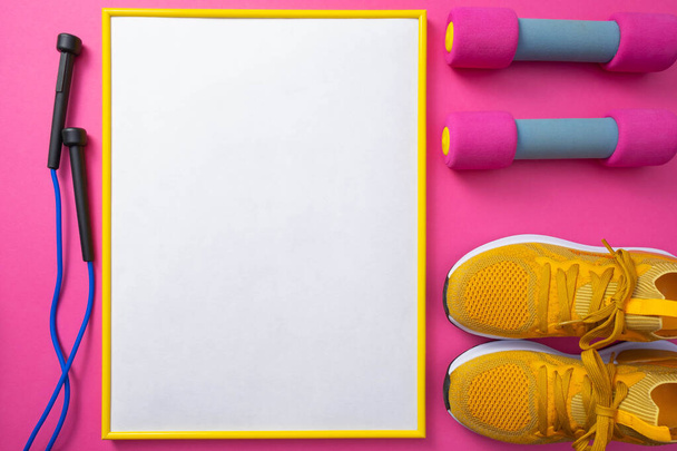 sports at home - dumbbells, sneakers, skipping rope on a pink background - Foto, Imagem