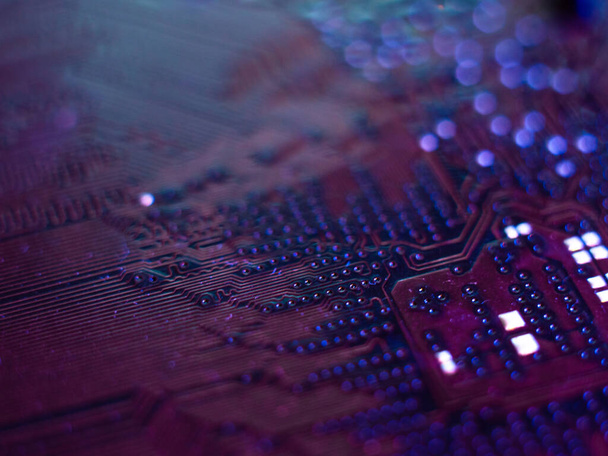 Computer motherboard, microchips close-up in color illumination, - Zdjęcie, obraz