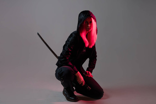 Techno cyber punk style, futuristic ninja, young woman with pink hair - 写真・画像