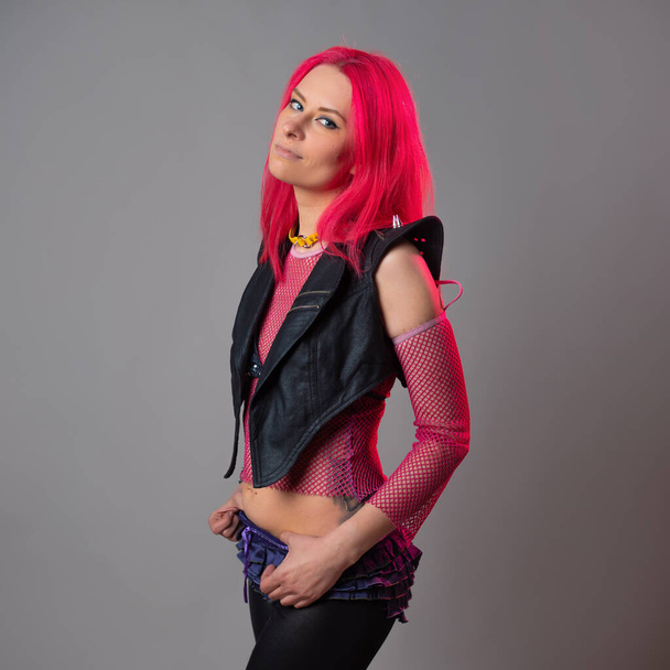 Futuristic fashion, a young bright and attractive woman with pink hair, - Photo, Image