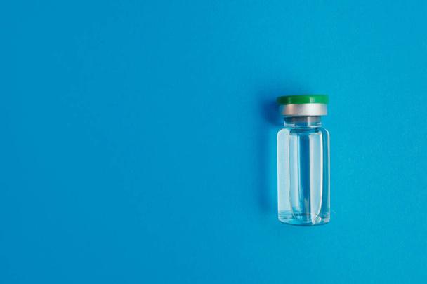ampoule with medicine on blue background - Фото, зображення