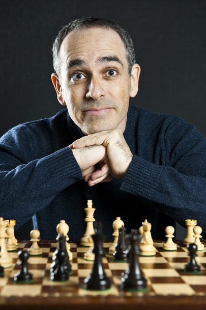 Chessboard with man thinking about chess strategy - Foto, imagen