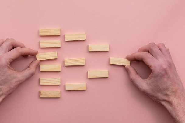 Hand choosing a wooden block from a flow chart. Business choice concept - Foto, Bild