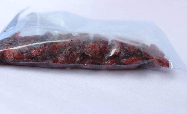 Dried cranberries in plastic packet  - Photo, Image