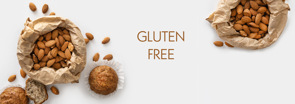 banner, almond flour gluten-free muffins, almonds in craft paper, keto food, on white background, top view, blank space for text - Photo, Image