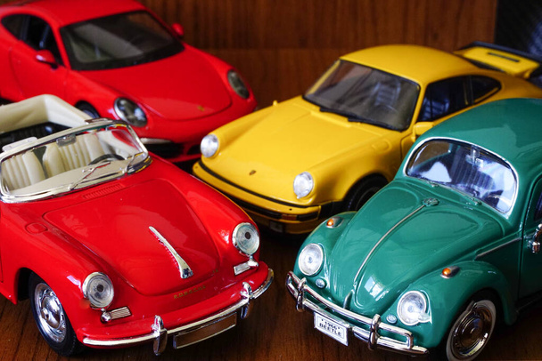 9 May 2021 Eskisehir Turkey New and Old Porsches and Beetle 1 24 diecast on wooden background - Foto, Imagem