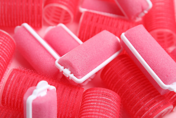 Different hair curlers on pink background, closeup. Styling tool - Photo, Image