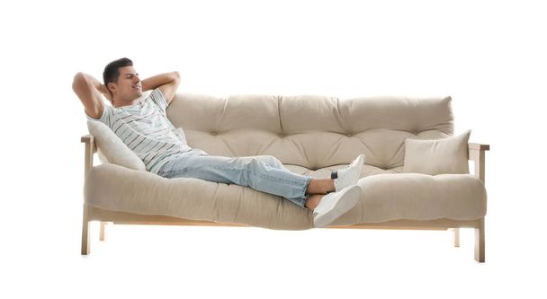 Man relaxing on comfortable sofa against white background - Photo, Image