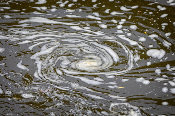 Swirl of water foam in shape of a spiral on river surface - Photo, Image