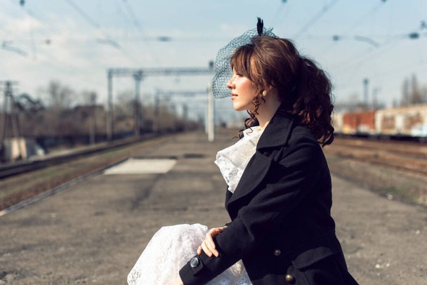 Young woman at the old train stop - 写真・画像