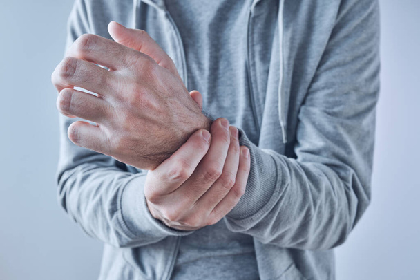 Rheumatoid arthritis, man suffering from severe pain in wrist, close up with selective focus - Φωτογραφία, εικόνα