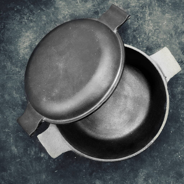 https://cdn.create.vista.com/api/media/small/472055776/stock-photo-cast-iron-pot-cover-lid-form-separate-frying-pan-top