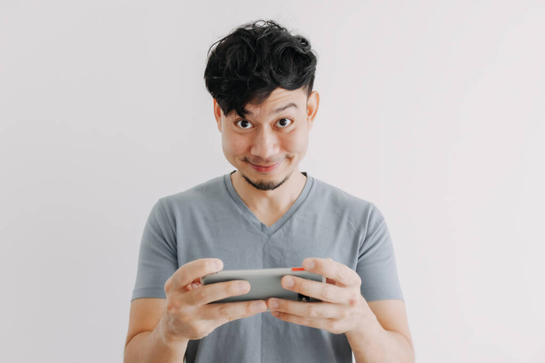 Happy man play online mobile game isolated on white background. - Valokuva, kuva