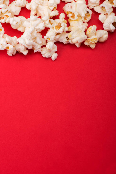 Heap of delicious popcorn isolated on background. Scattered popcorn texture background. Selective focus. - Photo, Image