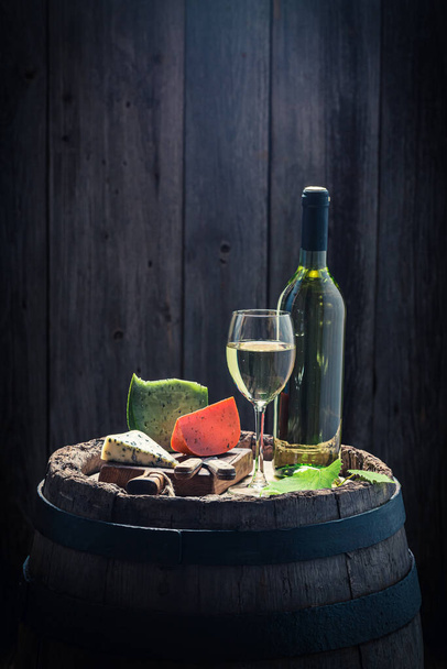 Chardonnay wine in glass with cheese. Wine industry. Wine and appetizer. - 写真・画像