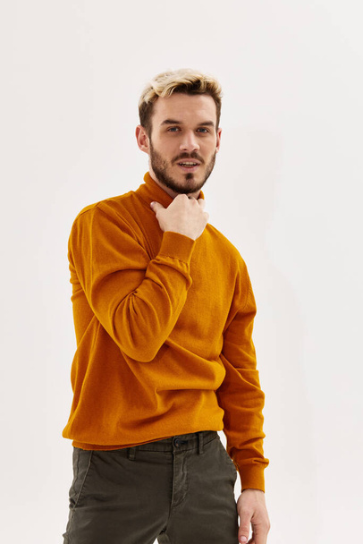 attractive man holding collar autumn style fashion light background - Foto, Bild