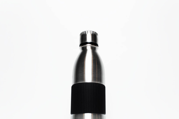 Close-up of reusable steel thermo water bottle with rubber handle isolated on white background. - Φωτογραφία, εικόνα