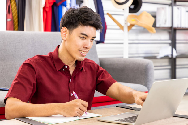 Genç Asyalı erkek online tüccar serbest blog yazarı evde dizüstü bilgisayarla çalışıyor. Sosyal medya, Nüfuz Edici ve online alışveriş konsepti. - Fotoğraf, Görsel