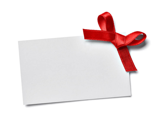 close up of a greeting card note with red ribbon on white background - Fotografie, Obrázek