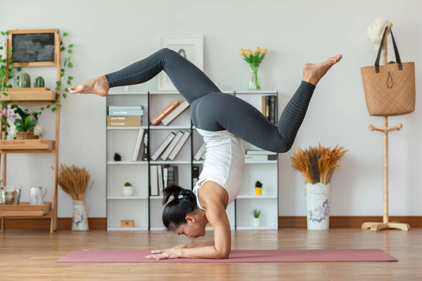Calm of Attractive asian Woman practice yoga ForearM stand or pinCha yoga to breathing meditation at home Feeling so comfortable and relax,Wellness Healthcare Concept - Foto, immagini