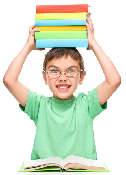 Little boy is holding a pile of books - Photo, Image